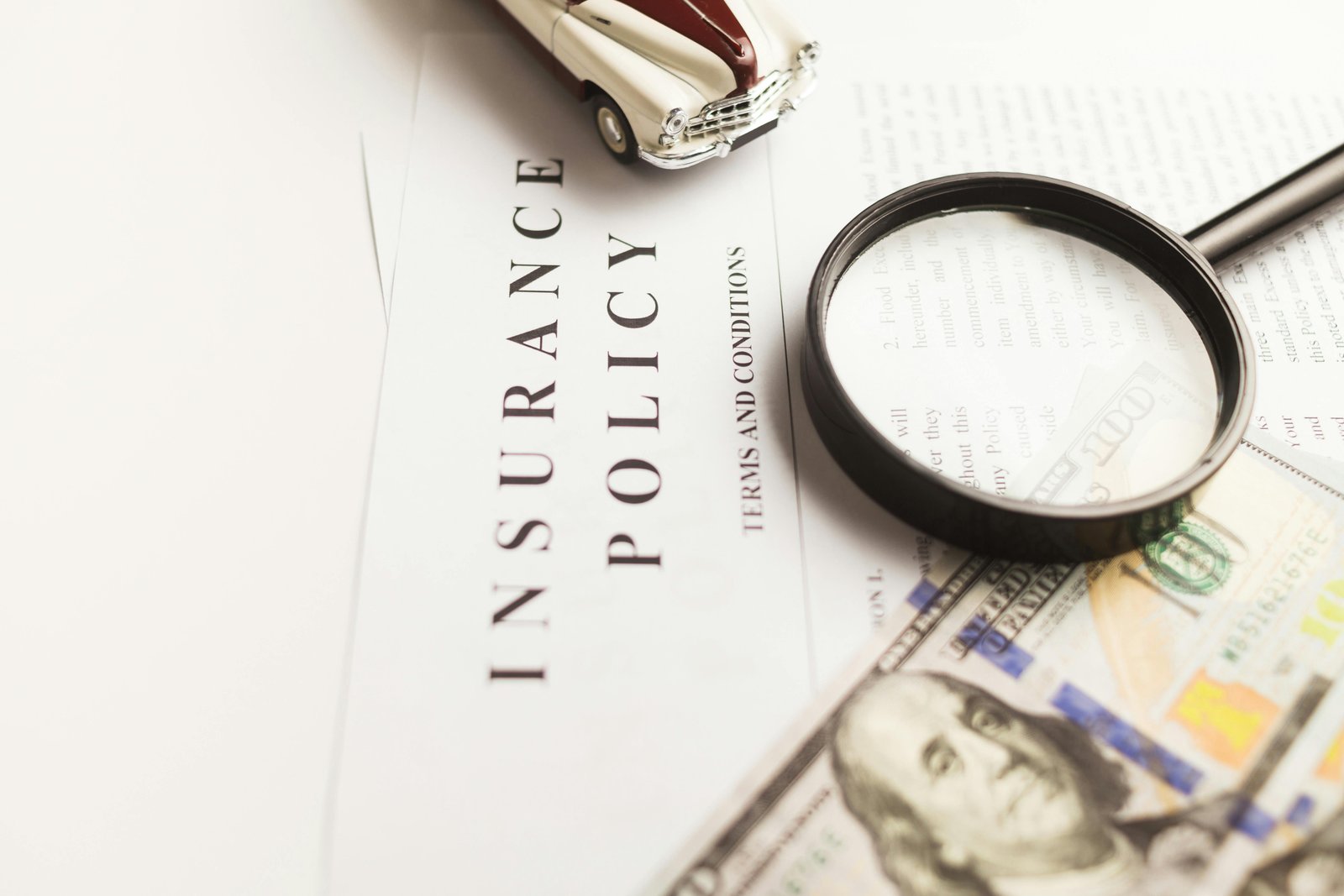 Car on a road with auto insurance coverage options and average premiums of $2,496/yr