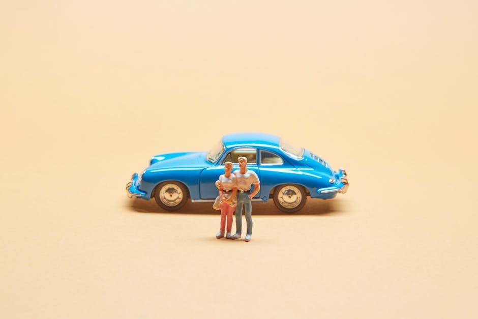 A miniature family contemplating their MyInsuredRide choices for their toy car, symbolizing family vehicle protection.