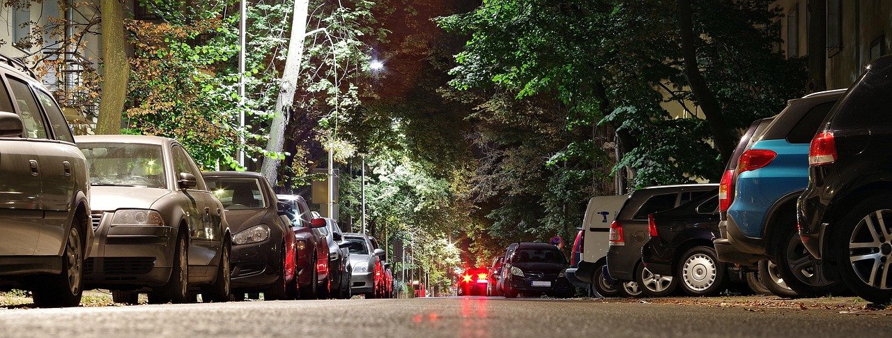 Street at night with cars and lights, symbolizing the need for Auto Insure Savings
