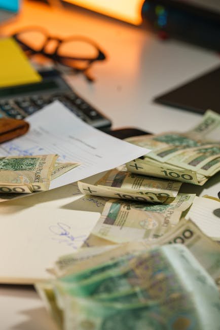 Scattered currency and financial documents, representing financial planning for Auto Insure Savings