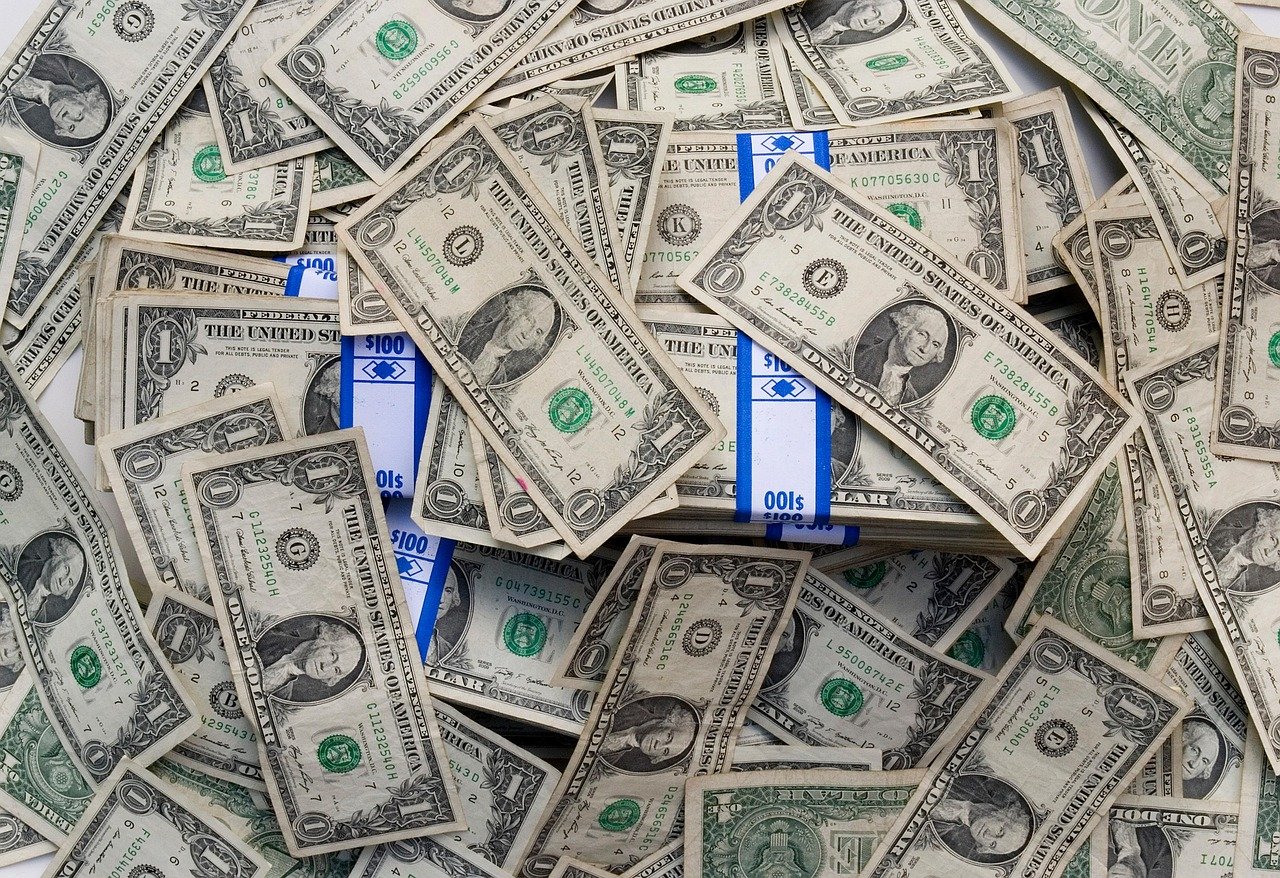 Close-up of US dollar bills, representing financial gains and Auto Insure Savings