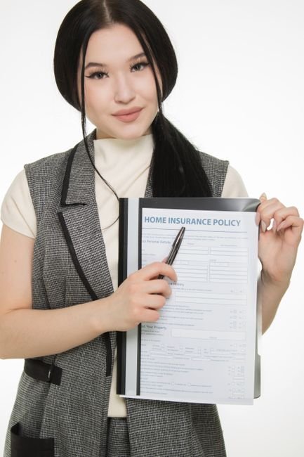 Quote Compare Now Home Insurance (quote compare now home insurance) Quote Compare Now Home Insurance - Young woman presenting a home insurance policy document while pointing with a pen.