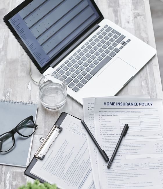 Quote Compare Now Home Insurance Quote Compare Now Home Insurance - Top view of a desk with laptop, insurance forms, and office supplies, ideal for business or finance topics.
