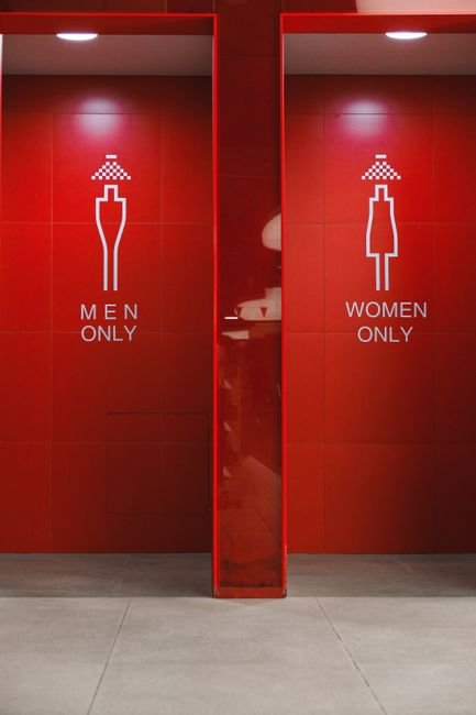 CompareMyQuotes Bathroom (comparemyquotes bathroom) CompareMyQuotes Bathroom - Stylish red restroom entrance with visible men and women only signs and tile walls.
